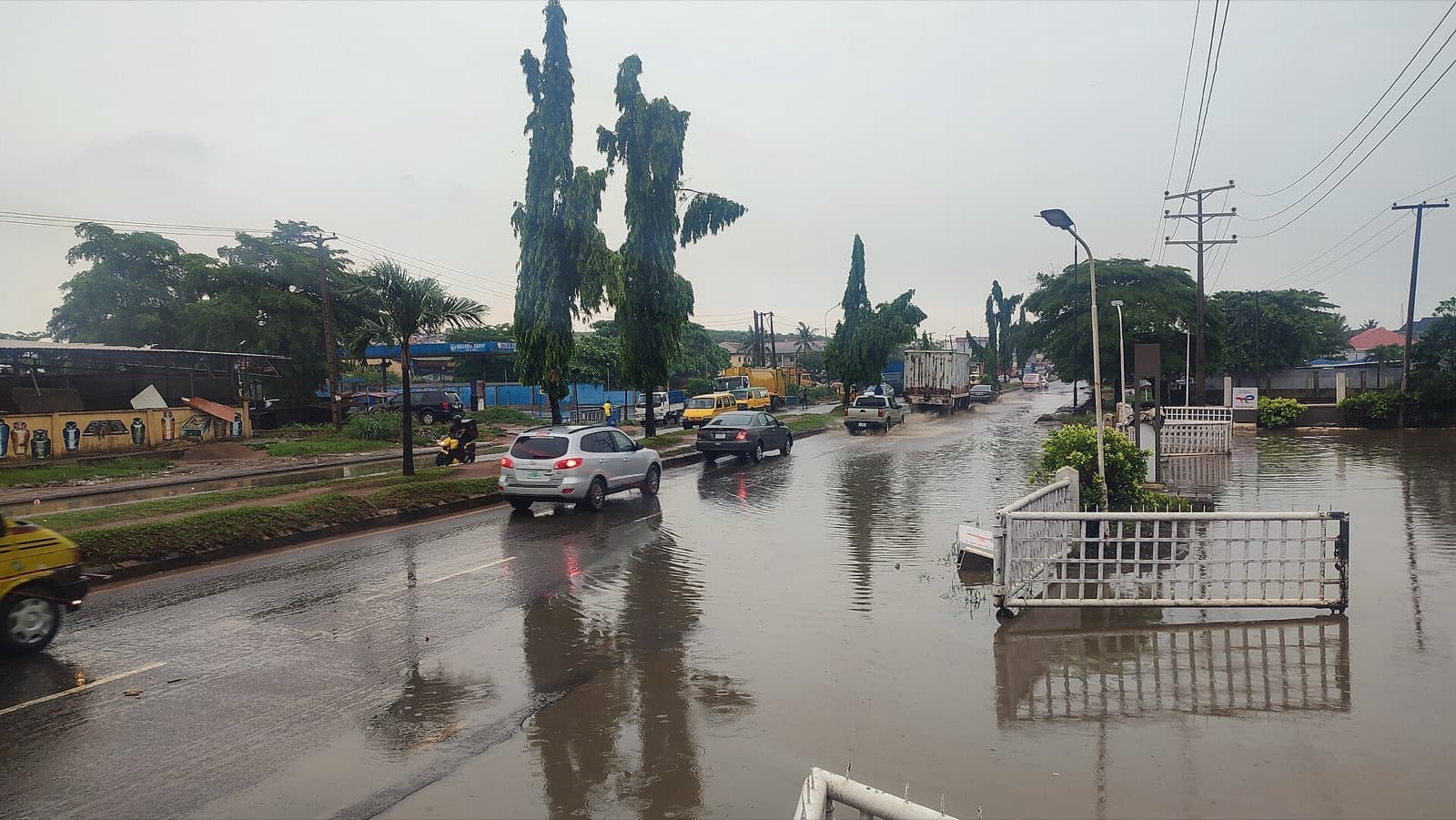 Cars driving through a flooded road in Lagos after rain